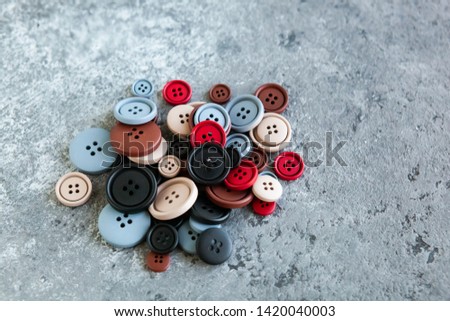 Pile color matte buttons on concrete background, macro bokeh. beautiful needlework, minimalism