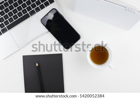 Stylish office table desk. Workspace with laptop, diary, succulent on white background. Flat lay, top view