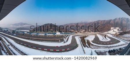 A picture of a racing circuit in a moutain range