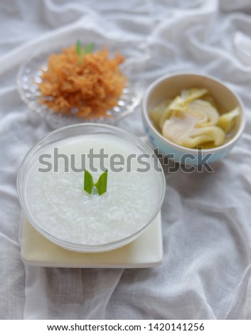 Rice mush pandan in bowl with dried shredded pork and canned cabbage,Selective focus.