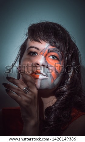 girl with a pattern on the face in a red dress