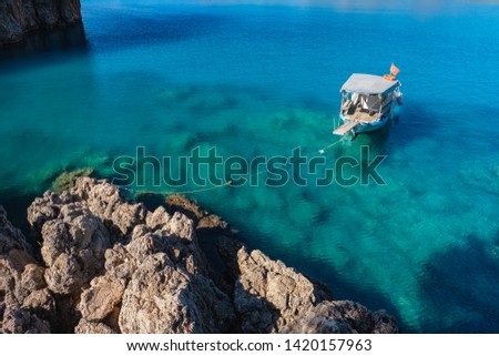 Boat in a Pirate bay or Korsan koyu, near the village of Karaoz, Mediterranean Sea, Turkey. One of the picturesque places on Lycian path