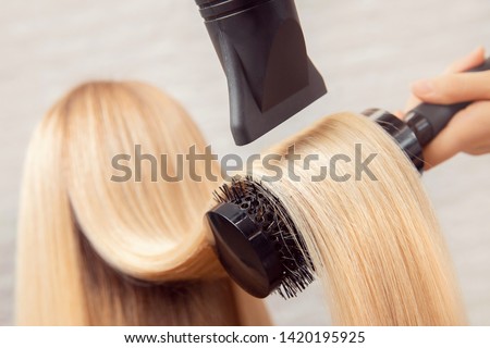Close-up of hair dryer, concept cut salon, female stylist. Royalty-Free Stock Photo #1420195925
