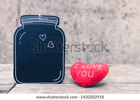 Retro style black wooden tag with hearts on wall. Simple and minimal frame and wallpaper. Copy space for text. Love photo concept and background.
