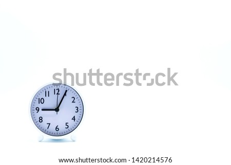 White alarm clock on white background. Copy space.
