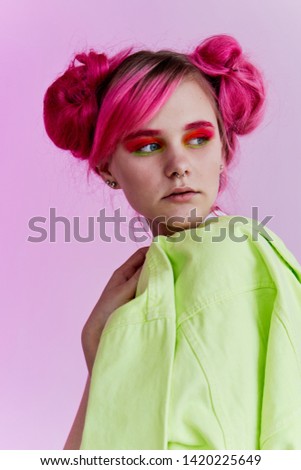 woman with bright makeup pink hair portrait