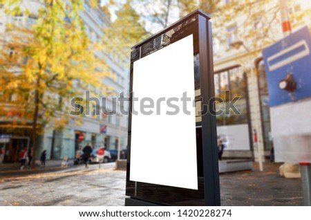 City vertical LED display mockup. Street and people in background.