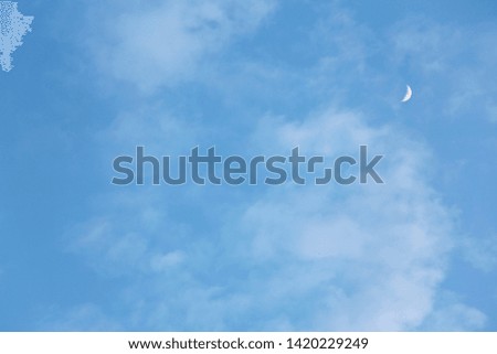 Moon on light blue sky, horizontal picture