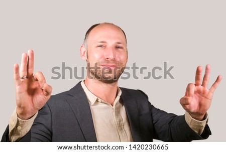 corporate company isolated portrait of young attractive and successful businessman smiling happy and confident isolated white background giving ok hand sign entrepreneur business success 