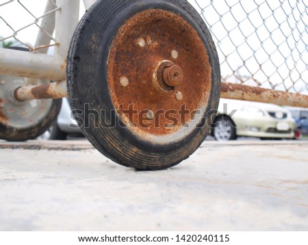 Rust on the wheel of the metal barrier panel with copy area. Selective focus