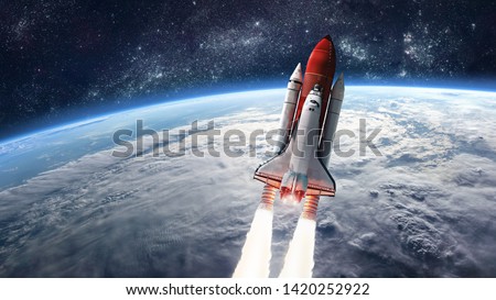 Space shuttle launch in the open space over the Earth. Ocean and sky under space ship. Elements of this image furnished by NASA