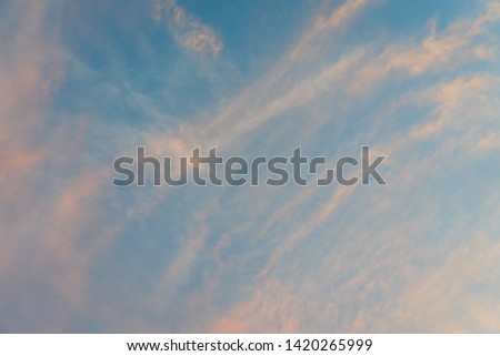 Clear blue sky with white clouds and reflective sunset in sunny day background