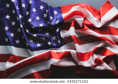 Patriotic composition w/ ruffled American flag on black background. United States of America stars & stripes symbol with copy space for text. 4th of july Independence day concept. Background, close up