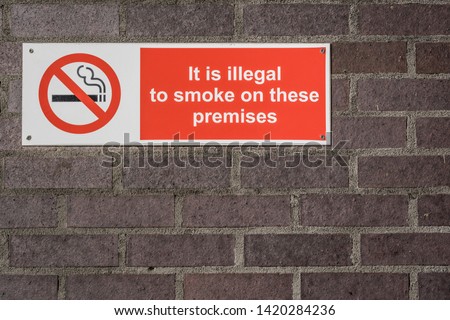 No smoking sign on a school wall.