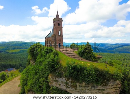Drone photography of St. Leon chapel dedicated to Pope Leo IX atop of Rock of Dabo. In french language roche de dabo.
Moselle-Vosges mountains and valleys with forest in the Background. Lorraine