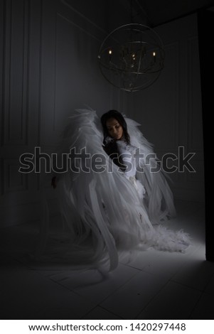 woman with angel wings in studio with white background,Horror background. Halloween background.