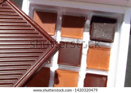 close up thin ribbed  dark and milk square chocolate                           