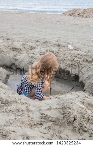 Little girl playing in the sand