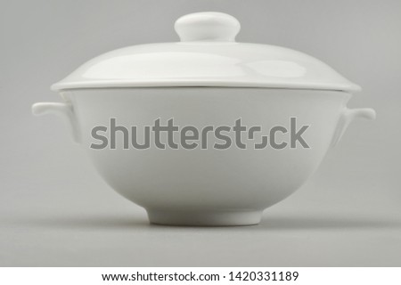 Large ceramic tureen on a gray background Royalty-Free Stock Photo #1420331189