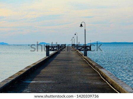 The bridge extends into the sea with soft focus