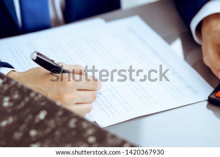 Bookkeeper or financial inspector hands making report, calculating or checking balance. Internal Revenue Service inspector man checking financial document. Business, tax and audit concepts