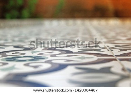 Picture of patio flooring beautiful vintage ceramic blurred background and brownish background with green leaves in the garden next to the kitchen