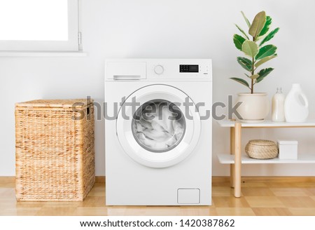 Washing machine with clothes in modern bathroom interior Royalty-Free Stock Photo #1420387862