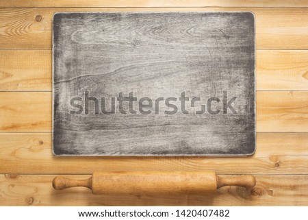 wooden sign board and rolling pin at rustic  plank table background, top view