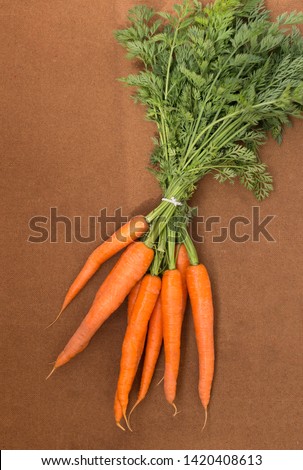 carrots on brown background. top view