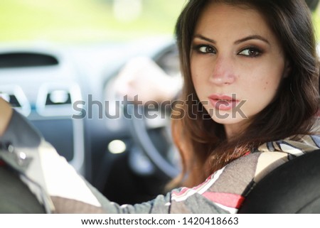 Girl driving a car bad emotions on her face
