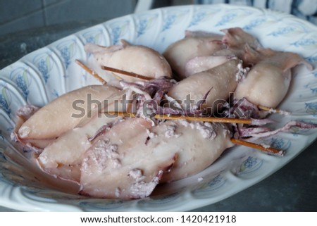 A selective focus picture of squids been serve as "ketupat sotong" or sticky rice in squid.
