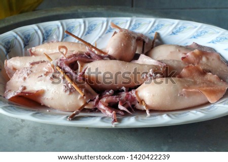 A selective focus picture of squids been serve as "ketupat sotong" or sticky rice in squid.