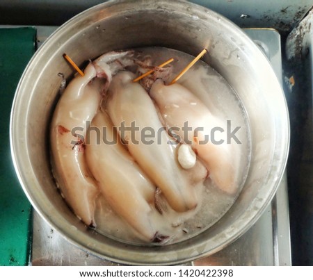 A picture of squids been boiled for "ketupat sotong" or sticky rice in squid.