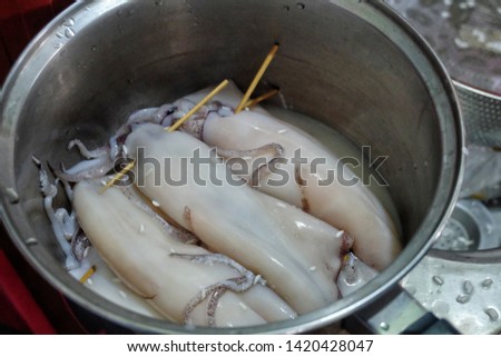 A picture of squids been prepared for "ketupat sotong" or sticky rice in squid.