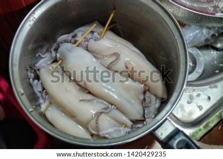 A picture of squids been prepared for "ketupat sotong" or sticky rice in squid.