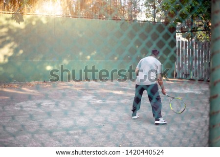 active old man exercise knock board tennis playing in morning. Good healthy with sport activities