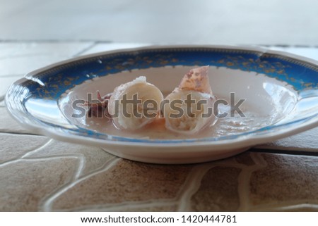 A selective focus picture of squid been cut and serve as "ketupat sotong" or sticky rice in squid.