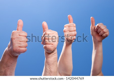 Female hands showing thumbs up, closeup