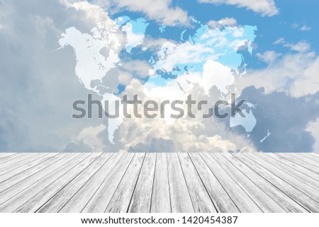 Cloudscape of natural sky with blue sky and white clouds in the sky use for wallpaper background with wood table or terrace and world map