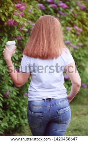 Beautiful hand with a stock of aromatic coffee in a beautiful park
