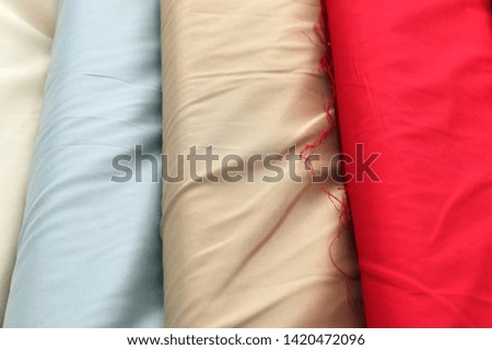 Close up view on colorful hanging and folded  fabrics and textiles in high resolution found on a fabrics market in Flensburg