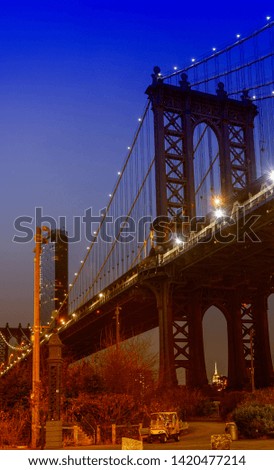 Night view of the Empire State Building through the pylons of Manhattan Bridge. View from Washington Street in Dumbo.