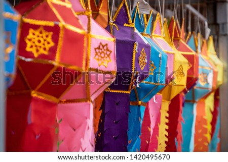 Colorful fabric lantern handicraft from northen of Thailand design decorated in the temple with faithful of people.