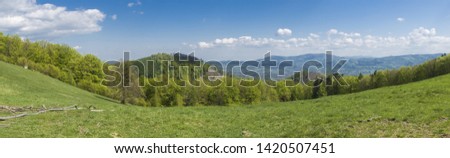 Landscape photography, image Czech Republic. Beskydy. Meadow, in the middle of the woods and mountains, in the background sky with clouds.