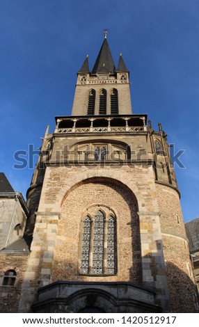 Tower of Aachen Cathedral at sunset. West Facade of Aix-la-Chapelle, Roman Catholic church in Aachen, western Germany.

