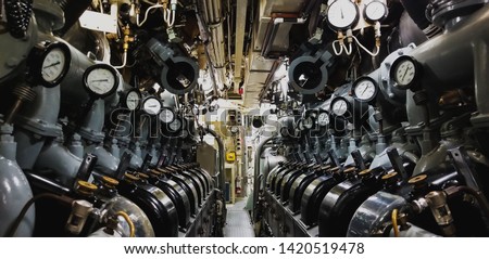 View of the inside of a submarine with the engine and pressure gauge. Royalty-Free Stock Photo #1420519478