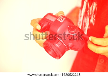 Closeup Of Man hand Using dslr camera, Red Colorful Trendy fashion style.- Image