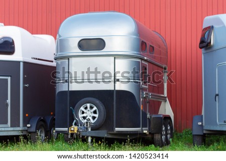 Several horse transportation trailers parked on the grass Royalty-Free Stock Photo #1420523414