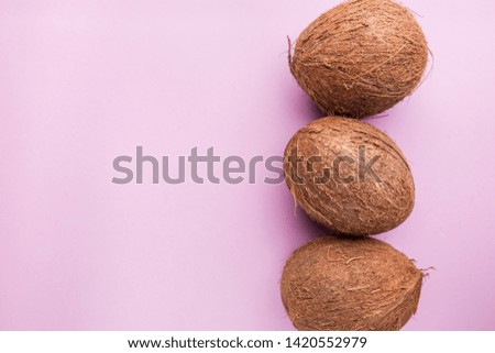 Pattern with ripe coconuts on pink background. Top View, copy Space, flat lay Pop art design, creative summer concept. Banner.