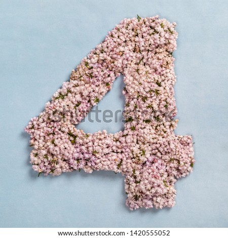 The number four is made of lilac flowers on a blue background.